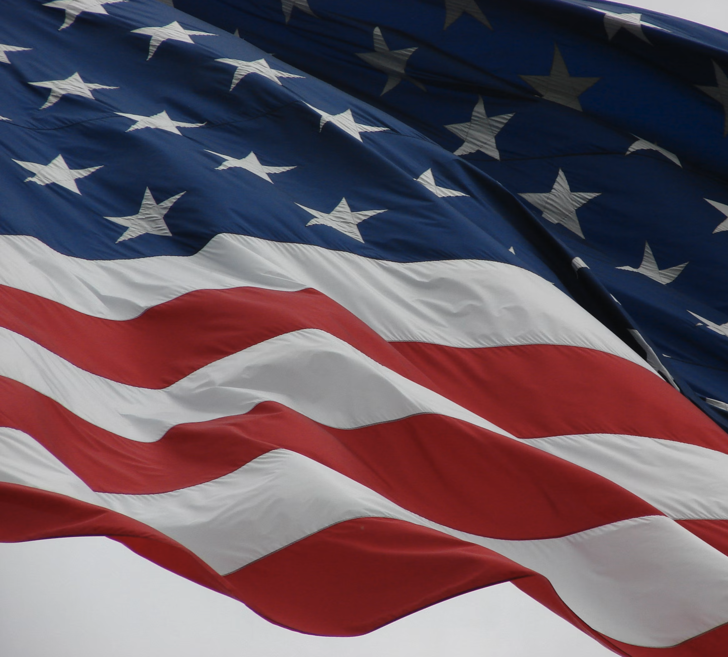 Close-up photograph of an American flag rippling in the wind